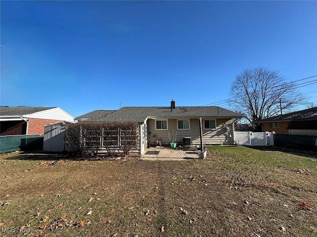 back of house featuring a yard, a patio, a shed, and central air condition unit