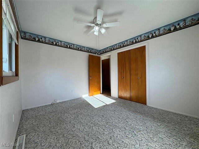 unfurnished bedroom with carpet, ceiling fan, and a closet