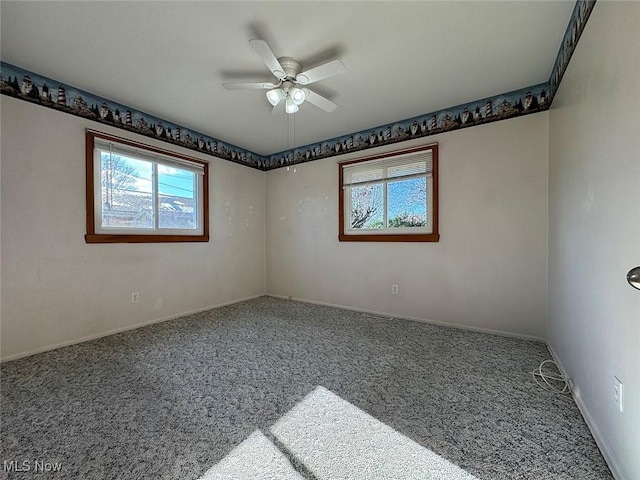 spare room featuring ceiling fan and carpet floors