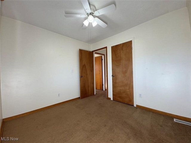 carpeted empty room with ceiling fan