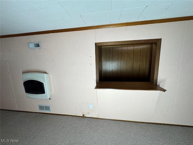 carpeted spare room featuring heating unit