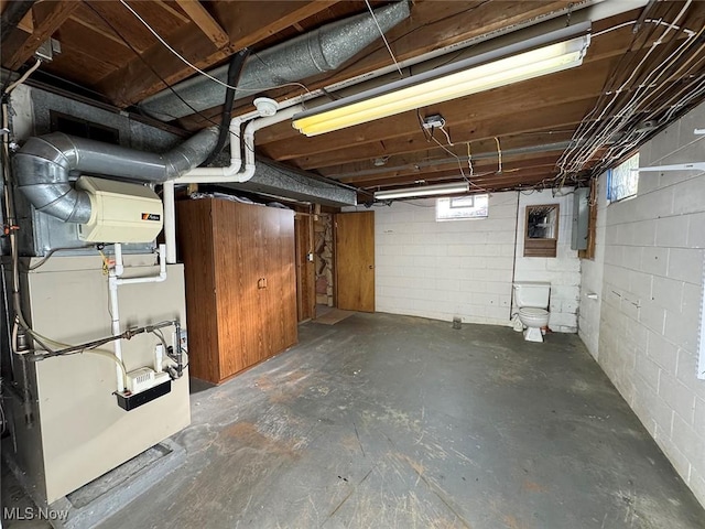 basement with electric panel and heating unit