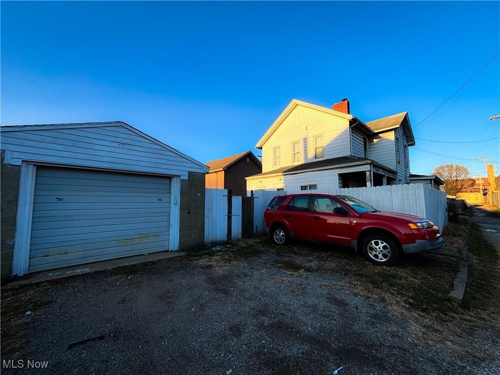 exterior space with a garage and an outdoor structure