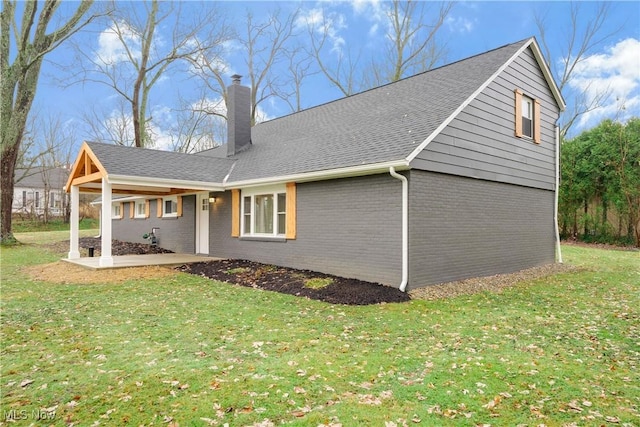 view of property exterior featuring a patio and a lawn