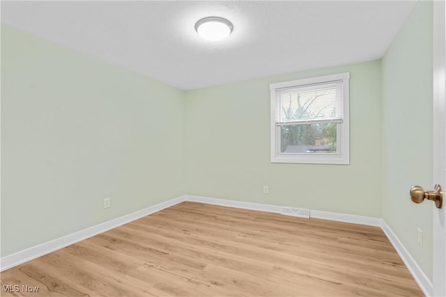 empty room with light hardwood / wood-style floors