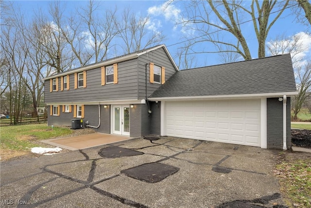 view of property with a garage and central AC