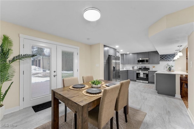 dining area with french doors and sink