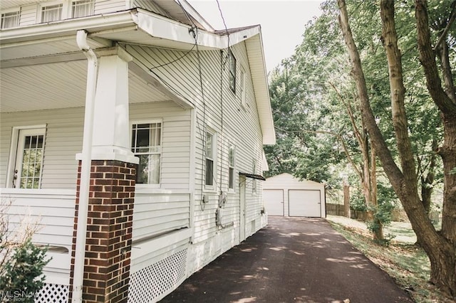 view of property exterior featuring an outbuilding and a garage