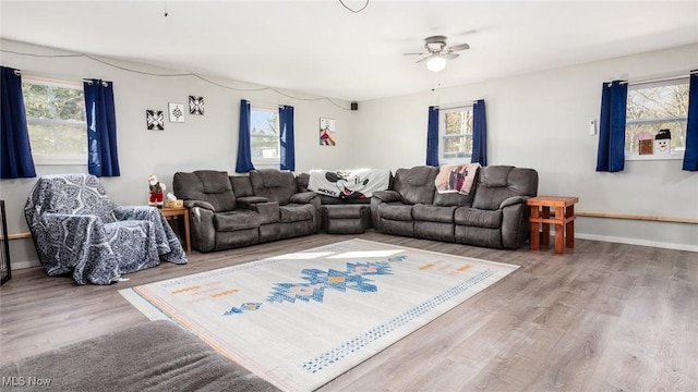 living room featuring wood-type flooring and ceiling fan