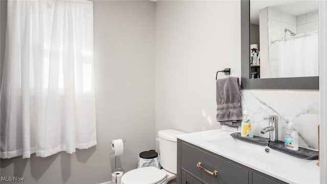 bathroom with vanity, a shower with shower curtain, and toilet