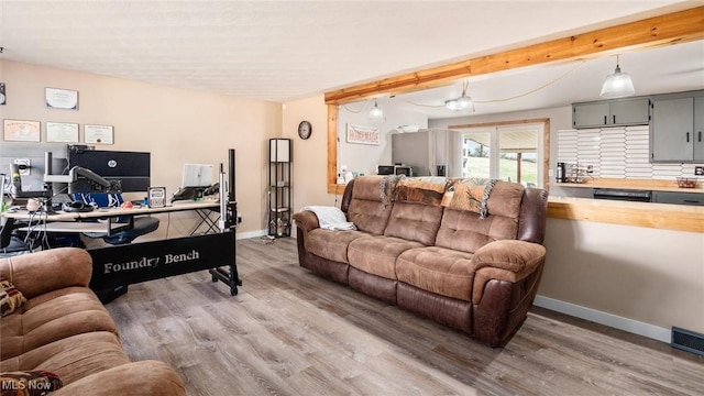 living room with wood-type flooring and beamed ceiling