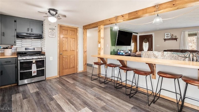 kitchen with dark hardwood / wood-style flooring, a kitchen breakfast bar, range with two ovens, decorative backsplash, and beam ceiling