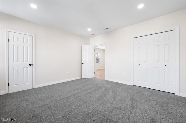 unfurnished bedroom with dark colored carpet