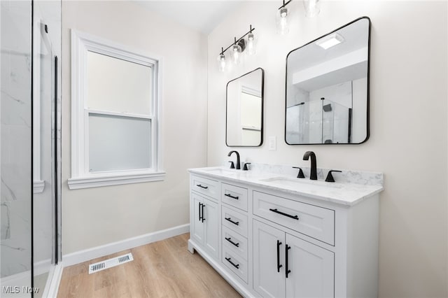 bathroom with vanity, hardwood / wood-style flooring, and an enclosed shower