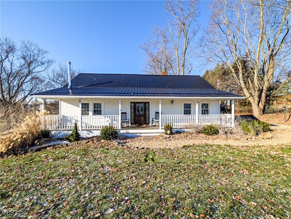 rear view of house featuring a yard