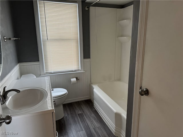 bathroom with hardwood / wood-style floors, vanity, toilet, and a wealth of natural light