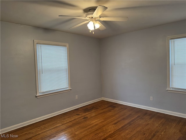 spare room with ceiling fan and dark hardwood / wood-style floors