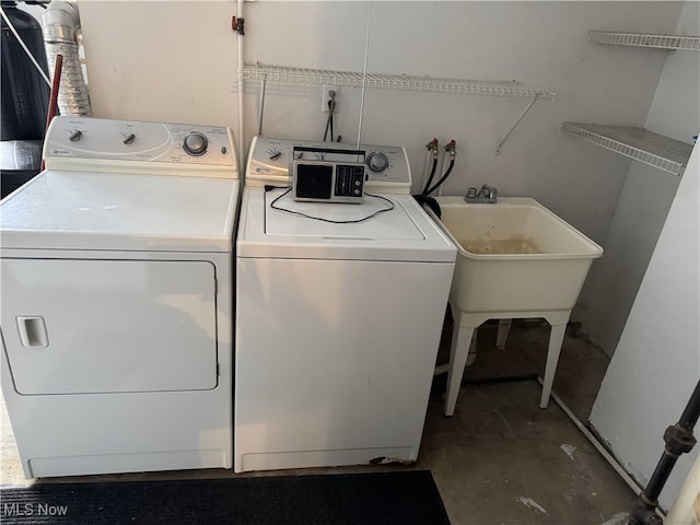 clothes washing area with washing machine and clothes dryer