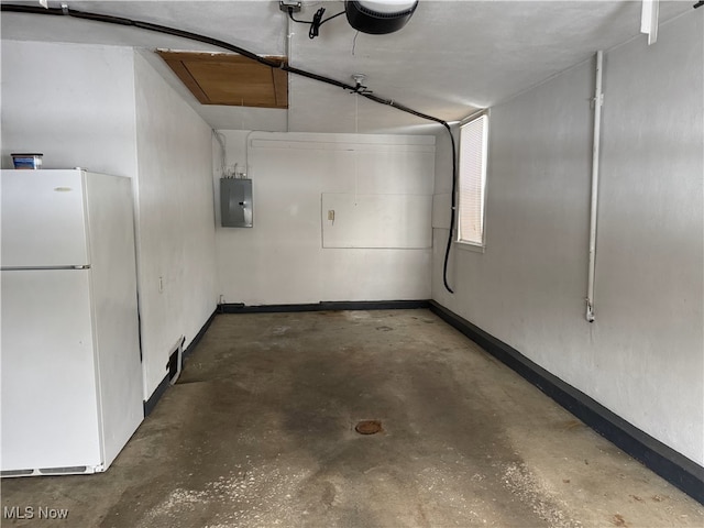 garage featuring electric panel, white fridge, and a garage door opener