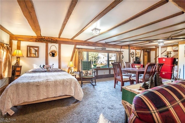 carpeted bedroom with beamed ceiling