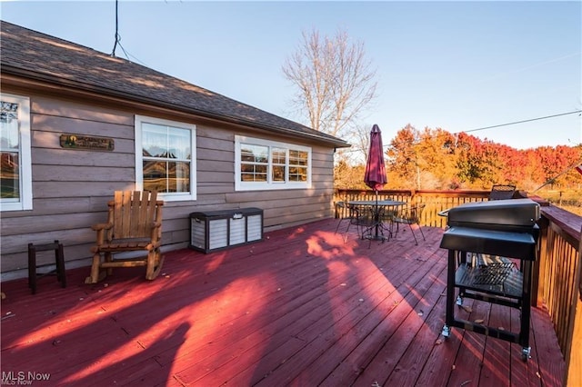 wooden deck featuring a grill