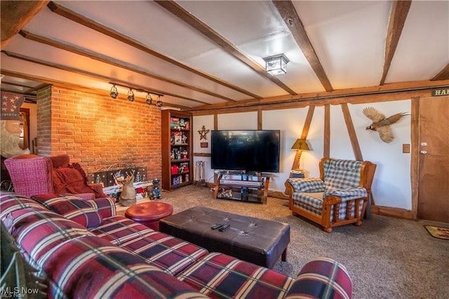 living room with rail lighting, a brick fireplace, brick wall, beamed ceiling, and carpet floors