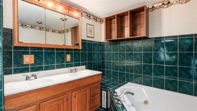 bathroom with vanity, tile walls, and a tub