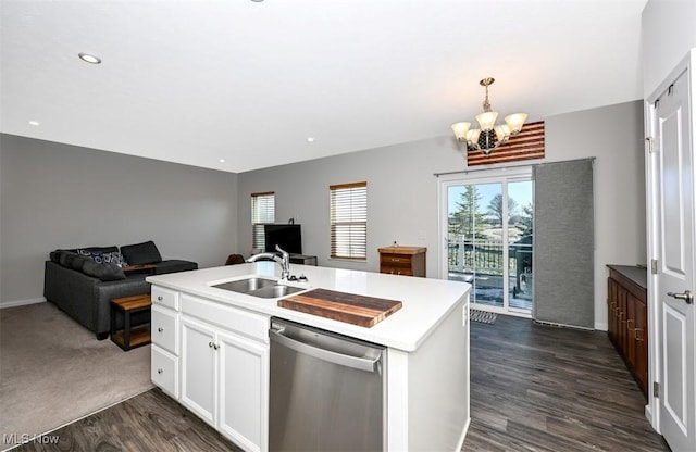 kitchen with dark hardwood / wood-style floors, white cabinetry, dishwasher, sink, and a kitchen island with sink