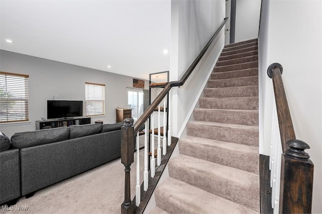 stairway featuring carpet and a wealth of natural light