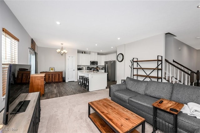 living room featuring dark hardwood / wood-style flooring and a chandelier