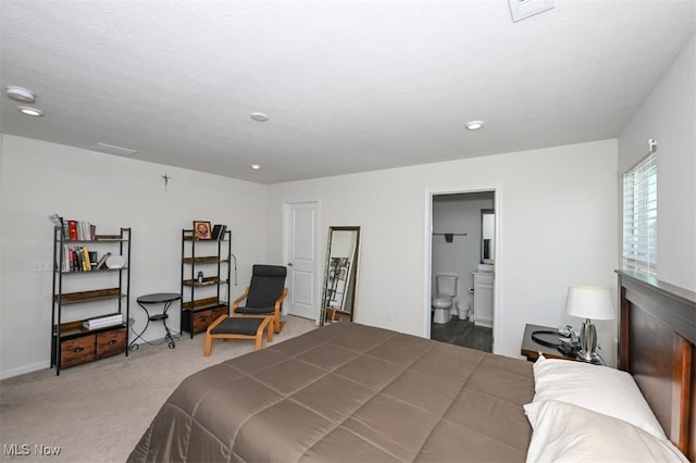 carpeted bedroom with ensuite bath