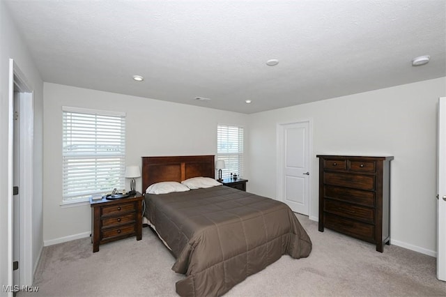 carpeted bedroom with multiple windows