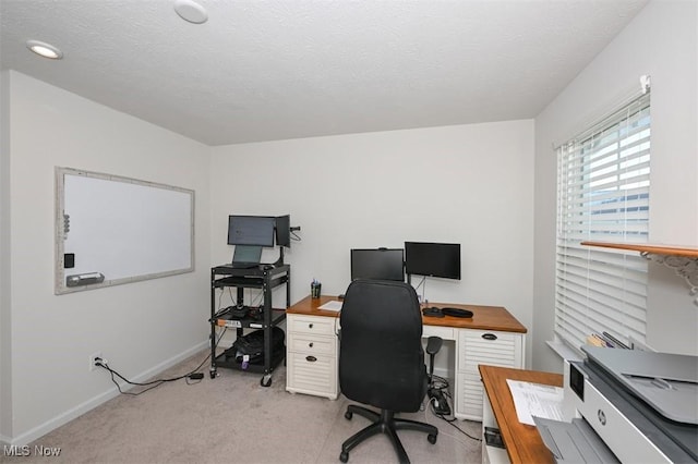 office area with light colored carpet and a textured ceiling