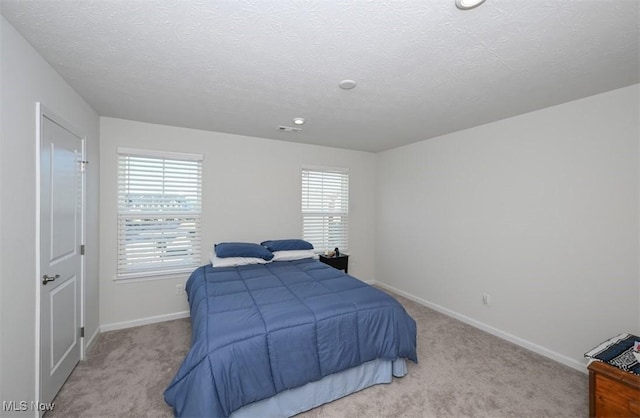 carpeted bedroom with a textured ceiling