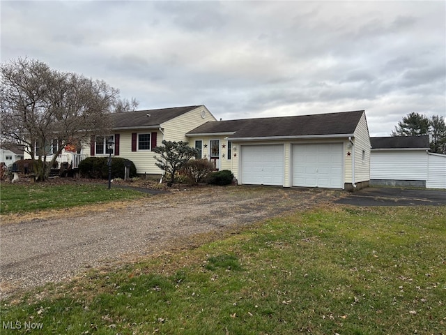 view of front of property featuring a front yard and a garage