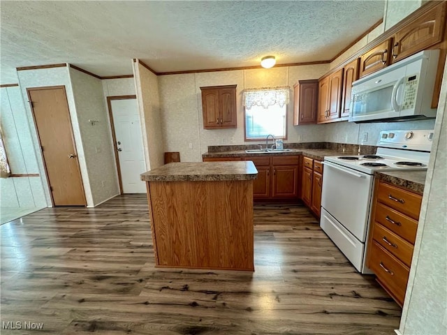 kitchen featuring a center island, sink, white appliances, and dark wood-type flooring