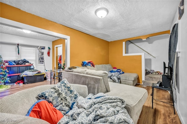 living room featuring hardwood / wood-style floors and a textured ceiling