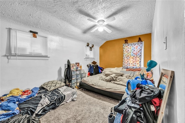 carpeted bedroom with a textured ceiling, ceiling fan, and lofted ceiling