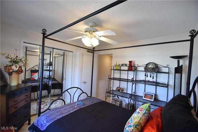 bedroom with ceiling fan, a closet, and a textured ceiling