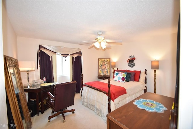 bedroom featuring a textured ceiling, carpet floors, and ceiling fan