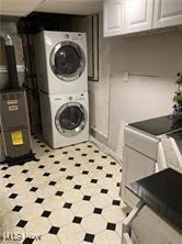 7355 W Blvd, Youngstown, OH 44512 - clothes washing area featuring stacked washing maching and dryer, baseboards, and laundry area