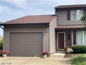 7355 W Blvd, Youngstown, OH 44512 - view of front facade with driveway and a garage