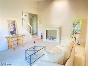 7355 W Blvd, Youngstown, OH 44512 - living room with carpet and stairs