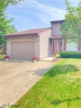 7355 W Blvd, Youngstown, OH 44512 - view of front of property with a front lawn, driveway, and a garage