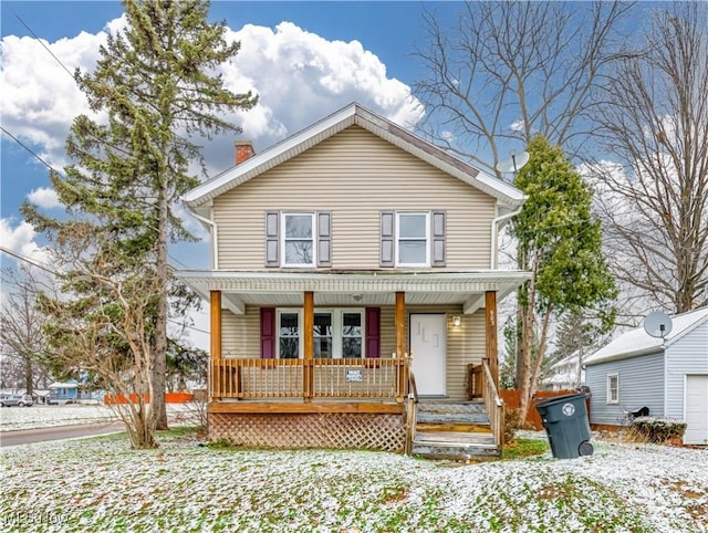 view of front of property featuring covered porch and a chimney