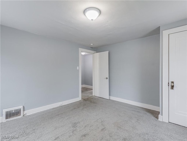 unfurnished room featuring light colored carpet