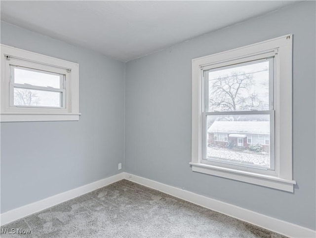 unfurnished room featuring light carpet