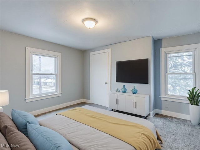 carpeted bedroom featuring baseboards