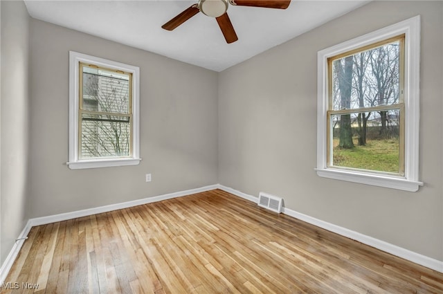 unfurnished room featuring ceiling fan, a healthy amount of sunlight, and light hardwood / wood-style floors