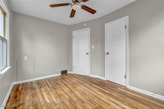 unfurnished bedroom with ceiling fan and light hardwood / wood-style flooring